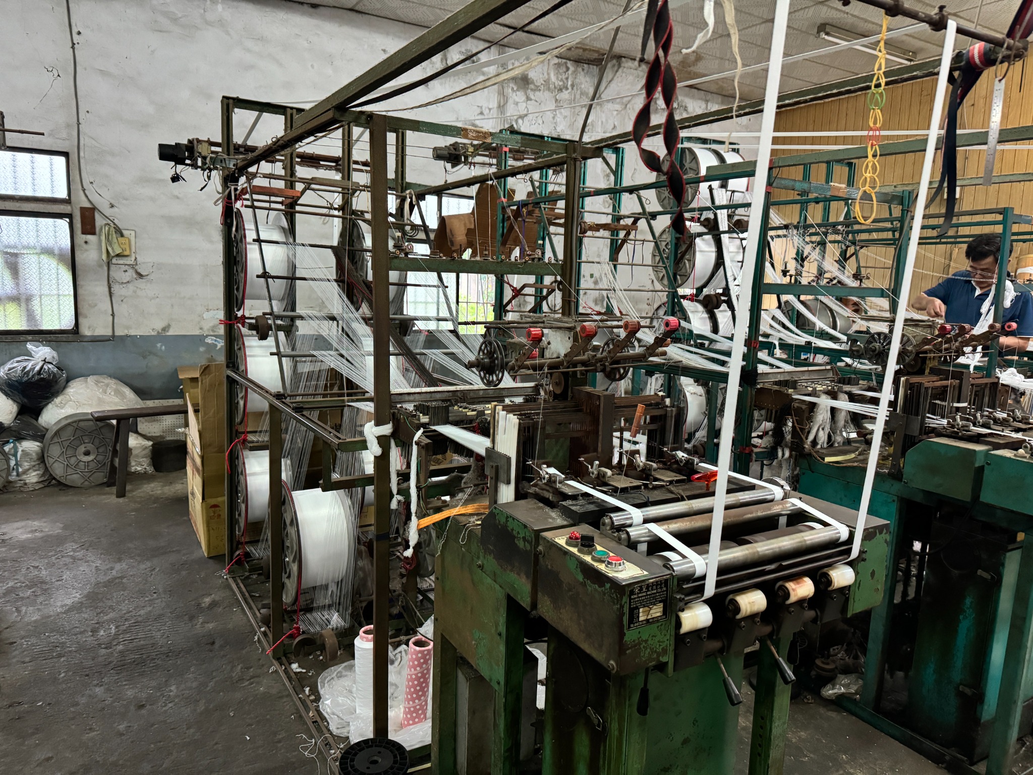 Machine weaving yarn into webbing